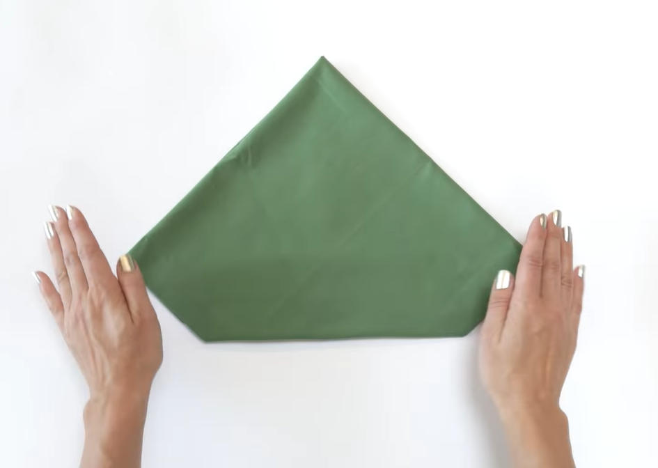 A Green Colored Napkin Folded And Flipped Over