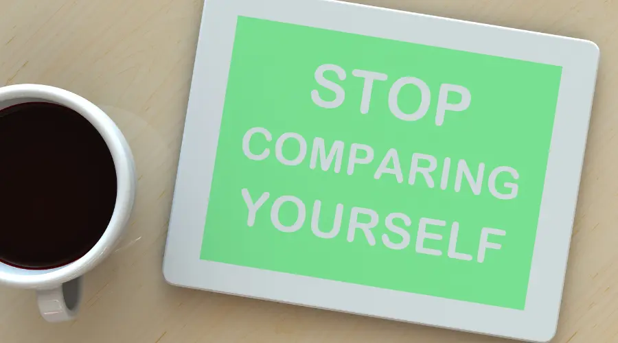 "Stop Comparing Yourself" Quote Written On A Green Board